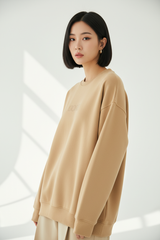 Luxury graphic sweatshirt in Honey Beige, three-quarter turn pose