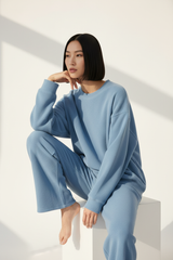 Luxury Oversized Sweatshirt Lounge Set — Powder Blue, Seated on Stool
