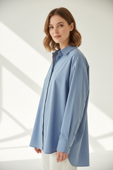 Oversized cotton shirt in Sky Mist Blue, three-quarter turn pose