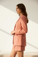 Model wearing dusty coral blazer shorts set, side profile shot