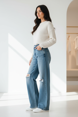 Premium distressed wide-leg denim pants in light wash blue - side profile