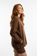 Women's knitted mini skirt set in mocha brown, side profile pose