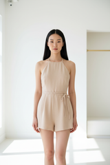 Luxury backless halter romper in Soft Beige – front view