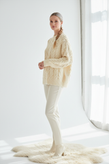 Luxury cable-knit sweater in Vanilla Cream, three-quarter turn pose