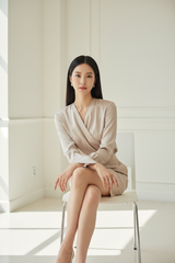 Satin Blouse in Soft Beige - Seated Pose