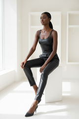 Premium Women's Faux Leather Slim-Fit Pants in Matte Black - Seated Editorial