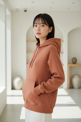 Luxury pullover hoodie in Dusty Terracotta, three-quarter turn pose