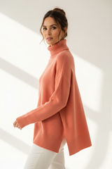 Luxury turtleneck sweater in Muted Coral, three-quarter turn pose