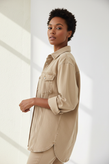 Luxury oversized denim shirt in Pale Sand, three-quarter turn pose