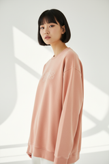 Luxury graphic sweatshirt in Washed Peach, three-quarter turn pose