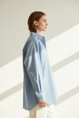 Oversized cotton shirt in Sky Mist Blue, side profile pose