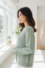 Luxury cardigan sweater in Soft Pistachio, side profile pose