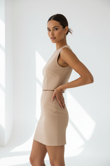 Women's co-ord skirt set in beige nude, three-quarter turn pose
