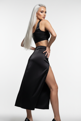 Women's satin slit skirt set in matte black, three-quarter turn pose
