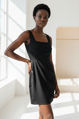 Luxury Square-Neck Mini Dress in Matte Black - hand on hip pose