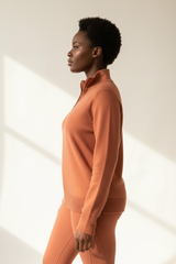 Luxury zip-neck sweater in Soft Terracotta, side profile pose