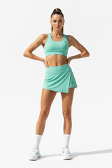 Women's sporty wrap mini skirt set in mint green, front-facing pose