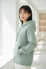 Luxury pullover hoodie in Soft Pistachio, three-quarter turn pose