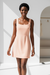 Luxury Square-Neck Mini Dress in Soft Peach - angled stance pose