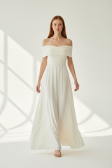 Luxury Off-Shoulder Maxi Dress in Soft Ivory - walking pose