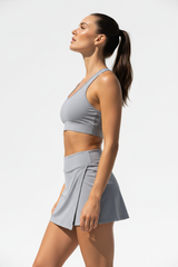 Women's sporty wrap mini skirt set in soft grey, side profile pose